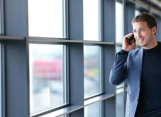 Man taking call on mobile indoors