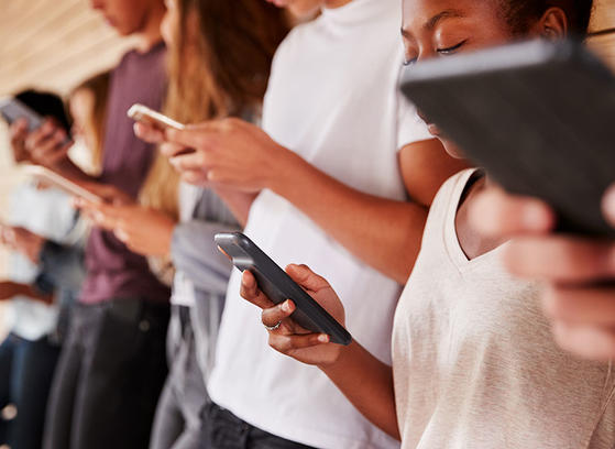 A group of people using mobile phones