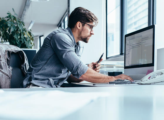 Business man in office working on network performance management