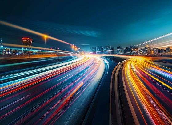 Blurred traffic background banner at night, symbolizing drive testing in a real-world urban environment