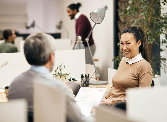 Team working together in open office environment