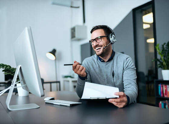 Man with headset working at helpdesk