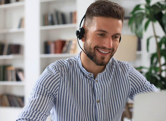 Man with headset working at helpdesk