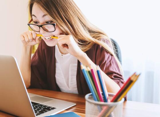 Frustrated woman looking at her laptop