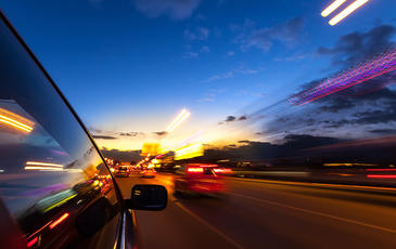 Car driving in the city at night
