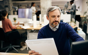 Man working at the office looking at screen