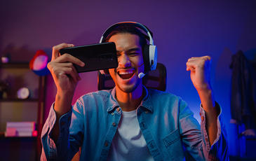 man with phone wearing headphones