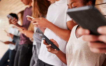 A group of people using mobile phones