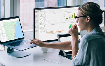 Woman looking at reports from TEMS Cloud, Infovista's real-time control and analytics solution