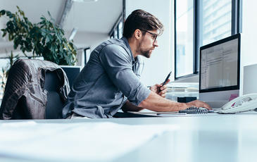 Business man in office working on network performance management