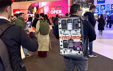 Solution engineer, Luis Najera, walking the floor at MWC25 with a TEMS backpack filled with testing devices.