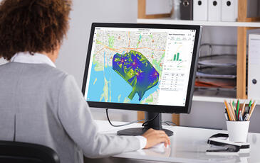 Woman looking at Planet Cloud SaaS wireless network report