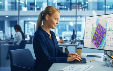 Woman working at computer desk.