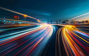 Blurred traffic background banner at night, symbolizing drive testing in a real-world urban environment