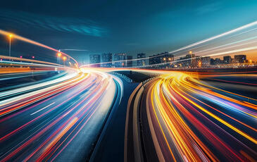 Blurred traffic background banner at night, symbolizing drive testing in a real-world urban environment