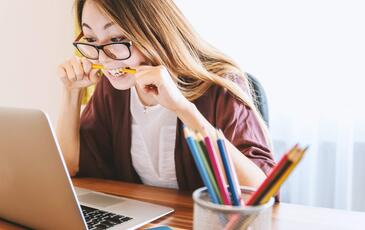 Frustrated woman looking at her laptop