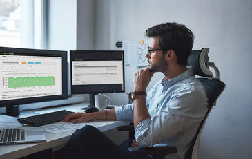 Man looking at VoiceWatch E2E performance reports