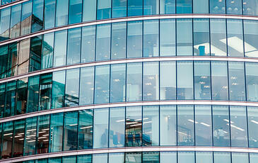 Closeup of financial building with corporate offices and employees