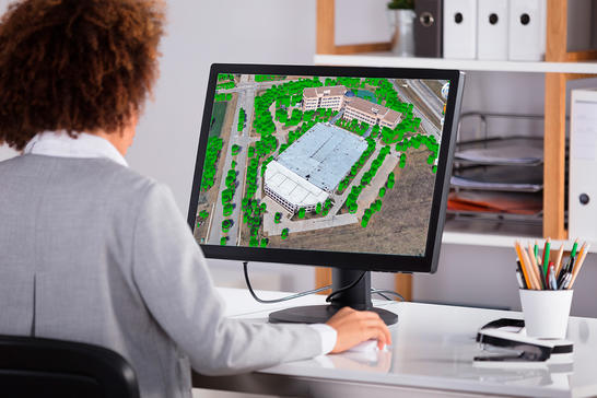Woman looking at 3D geodata for 5G planning