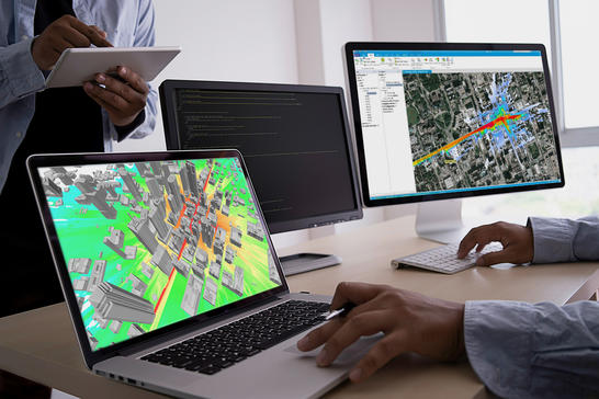 Person sitting in front of two monitors with Planet software