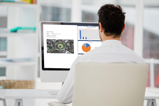 Man looking at report builder on screen