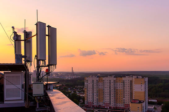 Cell tower on rooftop in urban city