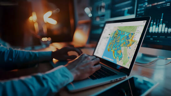Business professional using Planet Cloud on laptop to design and optimize fixed wireless access (FWA) networks faster.