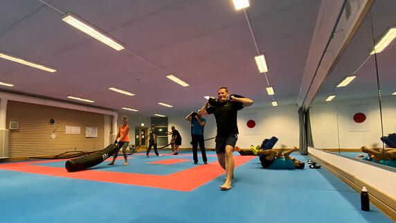 Colleagues enjoying a weekly indoor workout session, staying fit and energized together in a fun team setting.