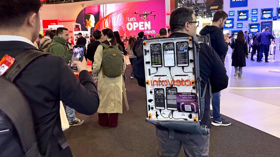 Solution engineer, Luis Najera, walking the floor at MWC25 with a TEMS backpack filled with testing devices.