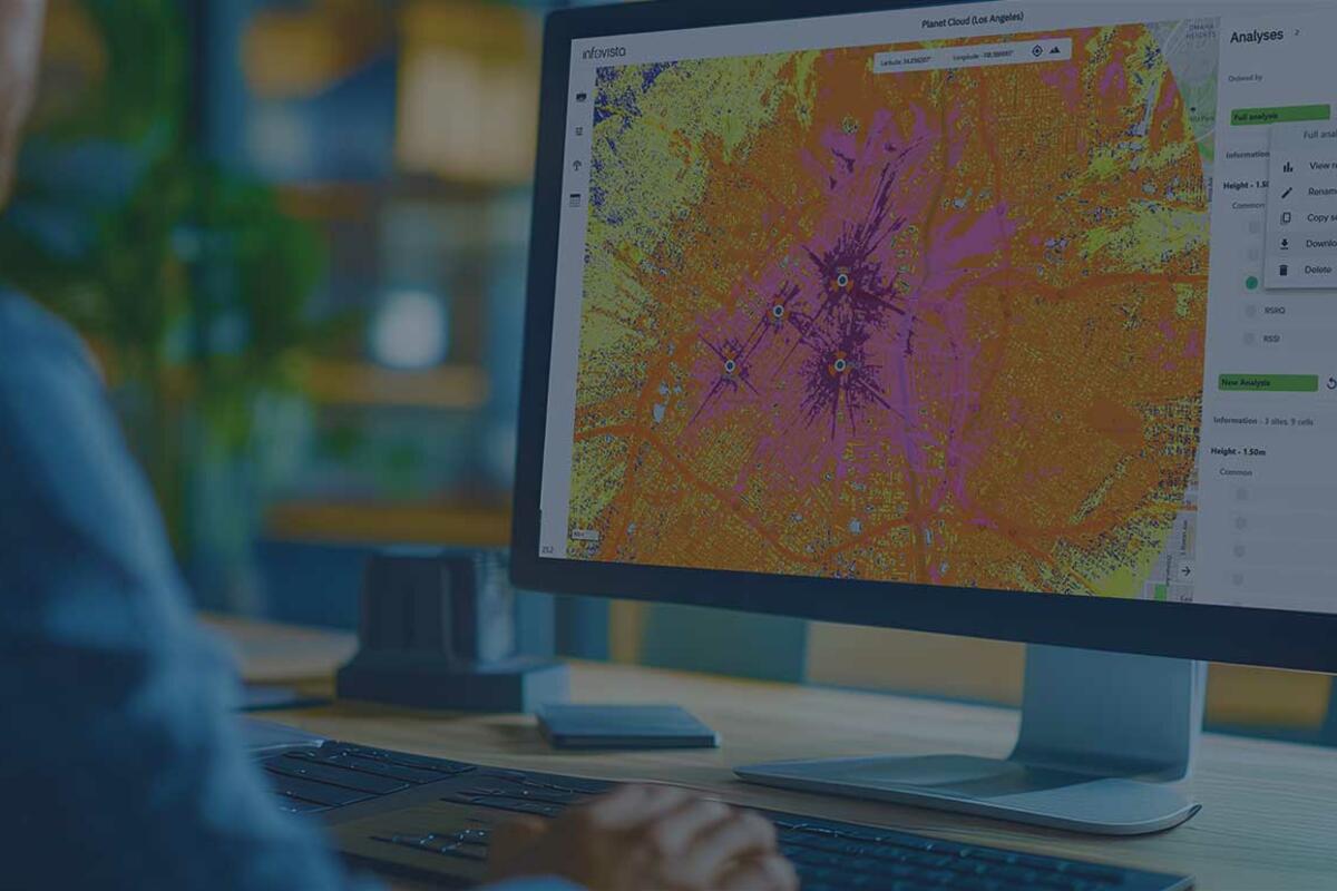 Man in office viewing a Planet Cloud dashboard - a SaaS-based RF planning platform built for speed, simplicity, and scalability