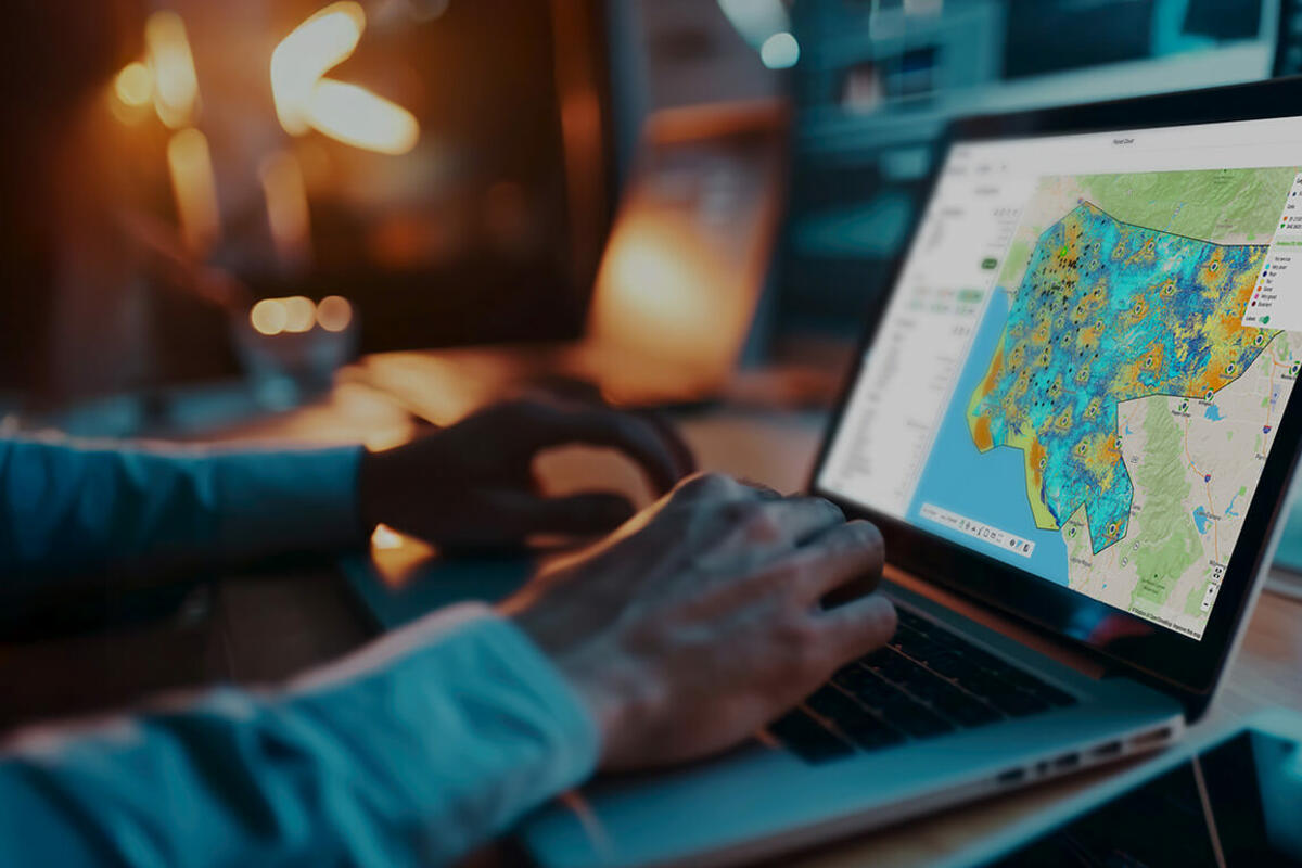 Business professional using Planet Cloud on laptop to design and optimize fixed wireless access (FWA) networks faster.
