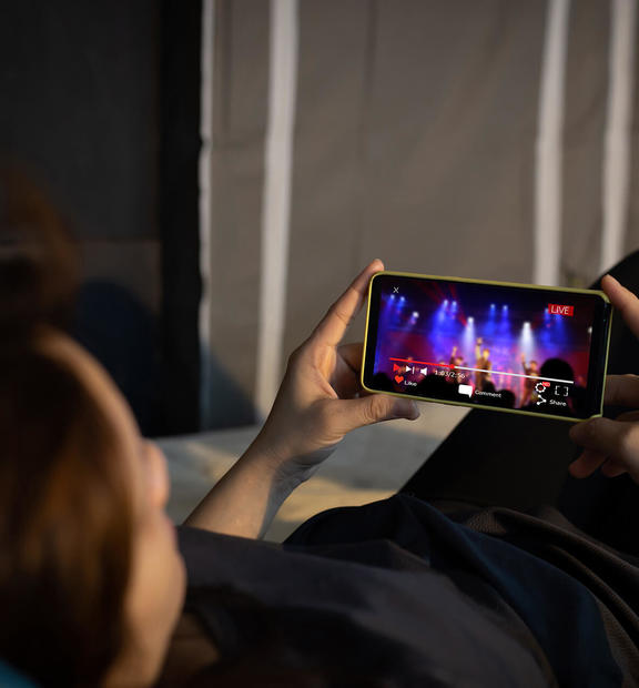 Guy looking at video on mobile phone