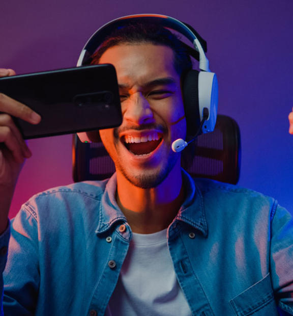 Man holding phone wearing headphones