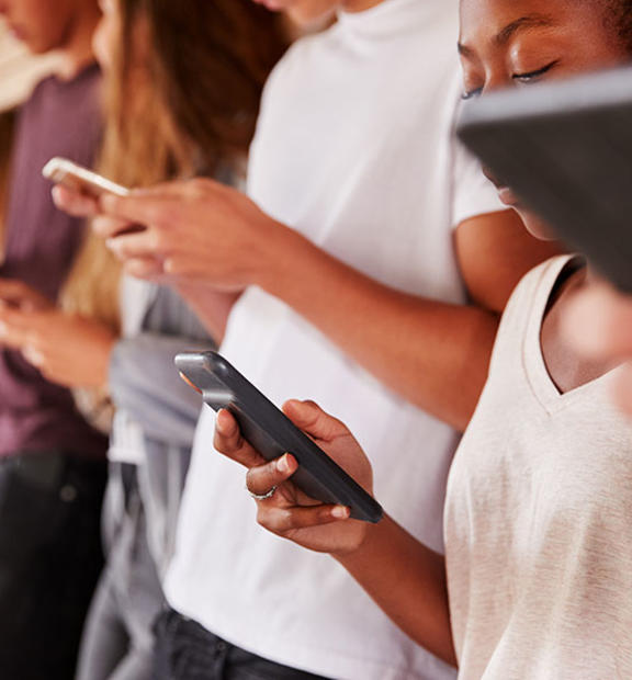 A group of people using mobile phones