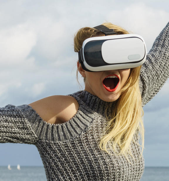 Woman wearing virtual reality glasses outside