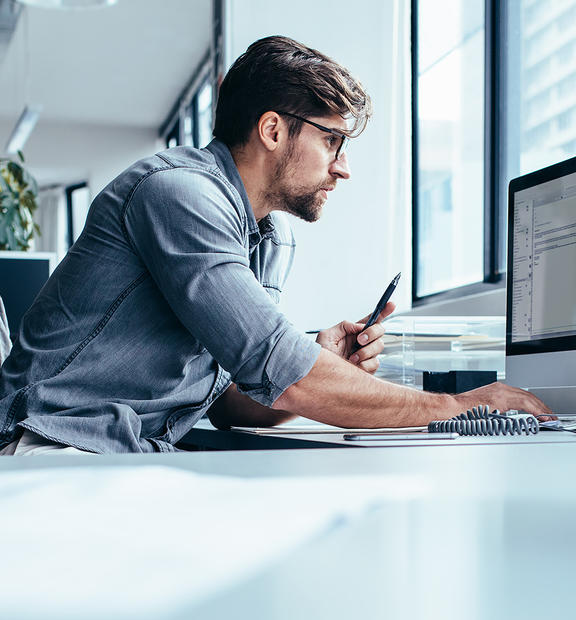 Business man in office working on network performance management