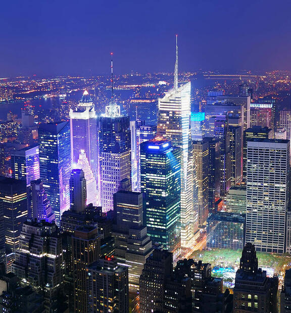 View over large dense city at night