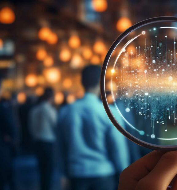 Hand holding magnifying glass, for holistic observability