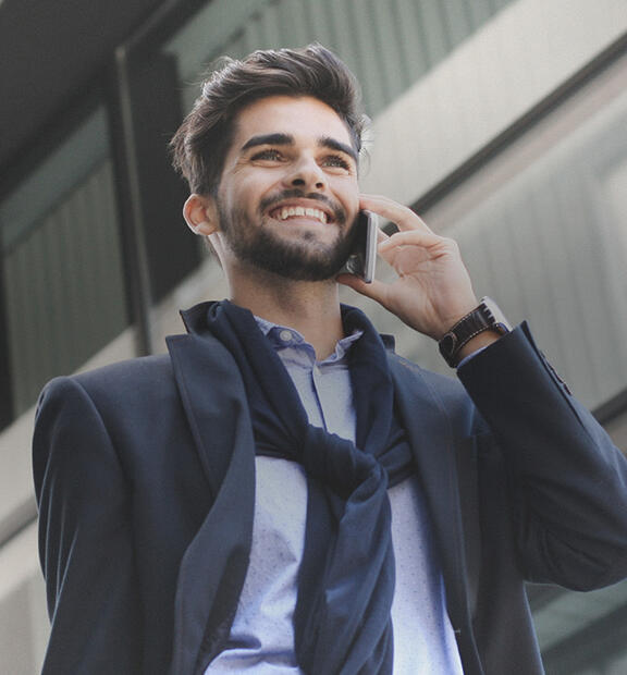 Business talking on the phone while walking in the city