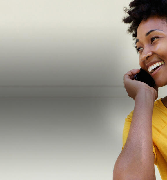 Happy woman talking on mobile phone