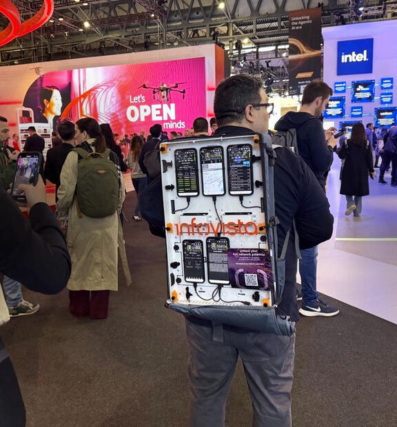 TEMS engineer performes walk testing across the MWC25 area with a TEMS Pocket Backpack filled with test devices