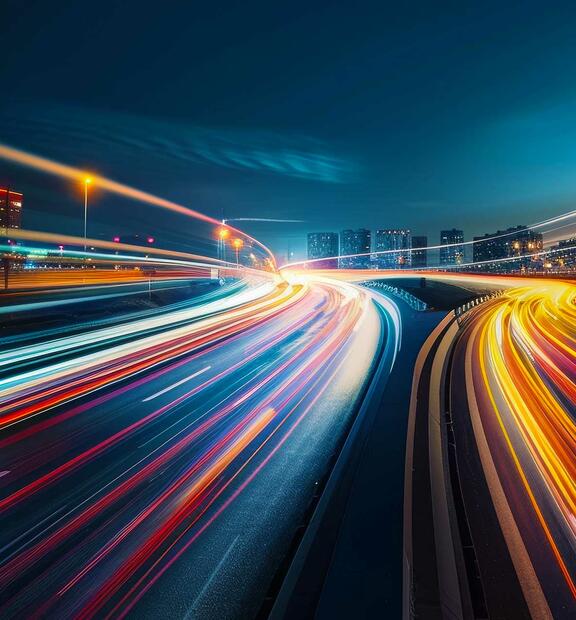 Blurred traffic background banner at night, symbolizing drive testing in a real-world urban environment