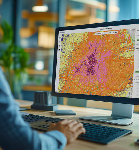 Man in office viewing a Planet Cloud dashboard - a SaaS-based RF planning platform built for speed, simplicity, and scalability