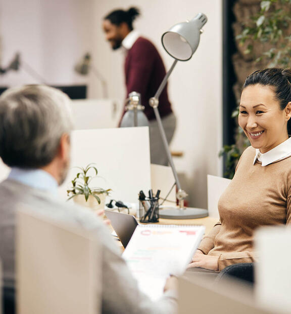 Team working together in open office environment