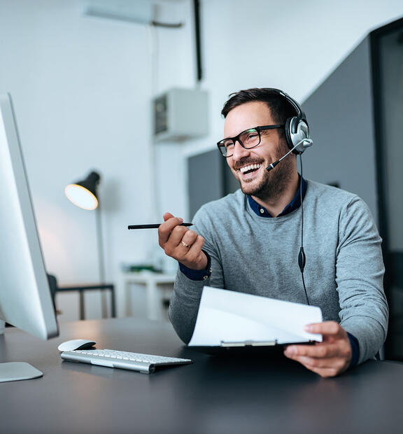 Man with headset working at helpdesk