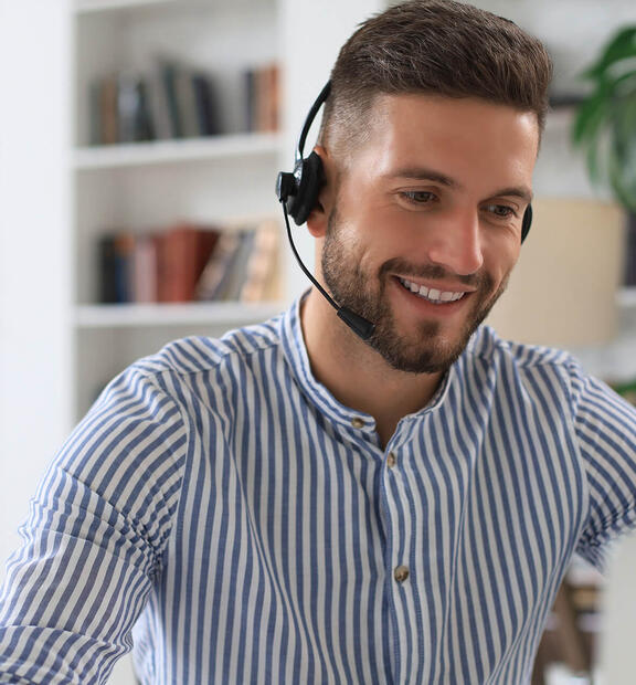 Man with headset working at helpdesk