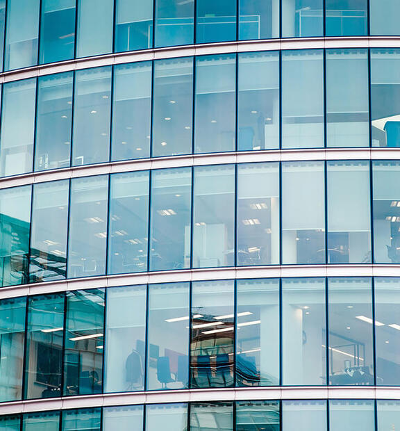 Closeup of financial building with corporate offices and employees