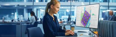 Woman working at computer desk.