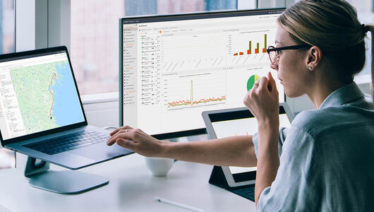 Woman looking at reports from TEMS Cloud, Infovista's real-time control and analytics solution