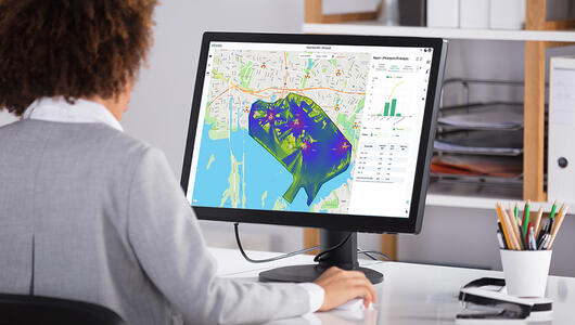 Woman looking at Planet Cloud SaaS wireless network report